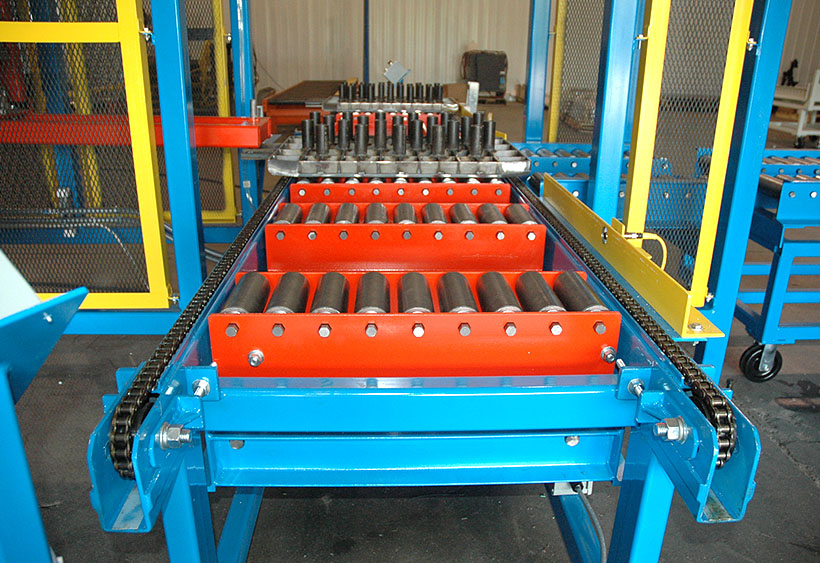 Two lane chain conveyor with pop-up gravity load station